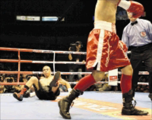 DUMPED: Raul Marinez, left, of Mexico is knocked down by Nonito Donaire of the Philippines during their IBF flyweight title bout in Manila, Philippines yesterday. Donaire retained his crown to win via technical knockout as the referee stopped the fight in the fourth round. 19/04/09. PIc. Aaron Favila. © AP.