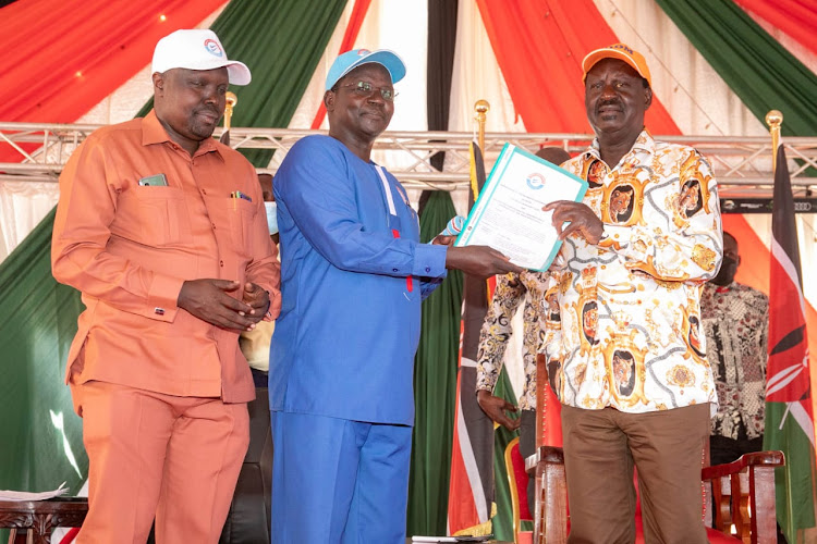 West Pokot Governor Prof. John Lonyamg'apuo hands over the document containing the issues of the community to ODM leader Raila Odinga.