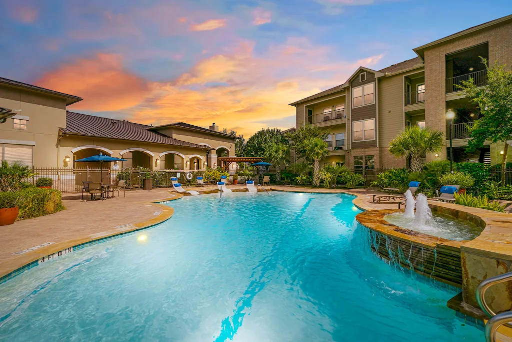 Resort-style swimming pool at dusk