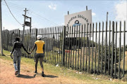 'HARASSED': Two Grade 10 pupils walk past Mandisa Shiceka High School in Kagiso where they accuse the principal of showing them pornographic clips on a cellphone during school hours.  PHOTO: MOHAU MOFOKENG