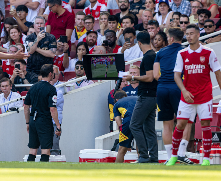 Referee Darren England reviews a replay on the VAR screen during a past Premier League match