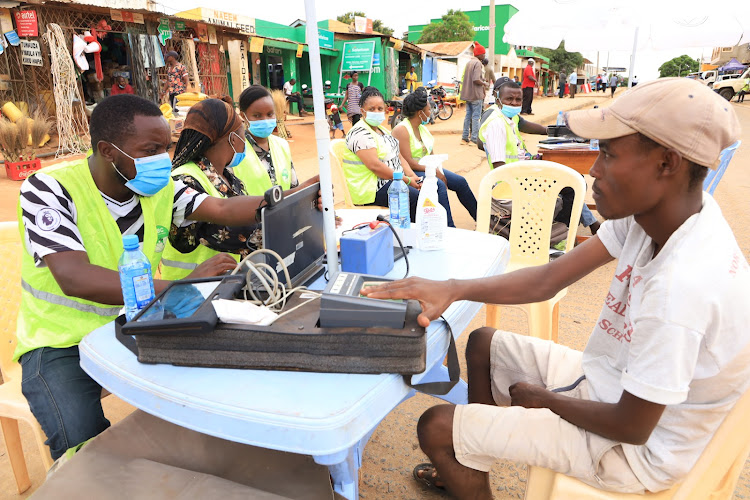 Josiah Kirigha registers as a voter at Mwatate market on January 23, 2022. IEBC targets to register at least 33,732 new voters in the region