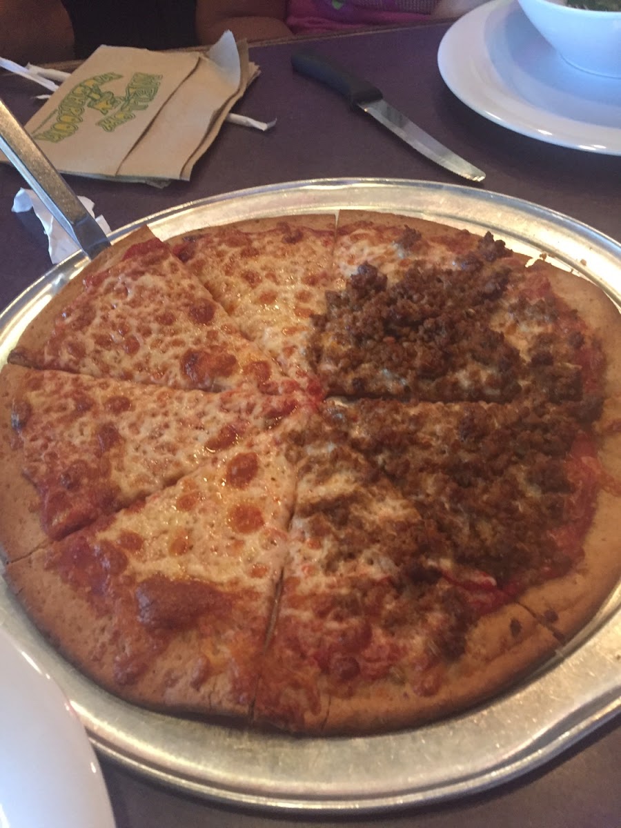 Yummy cheese pizza with half sausage