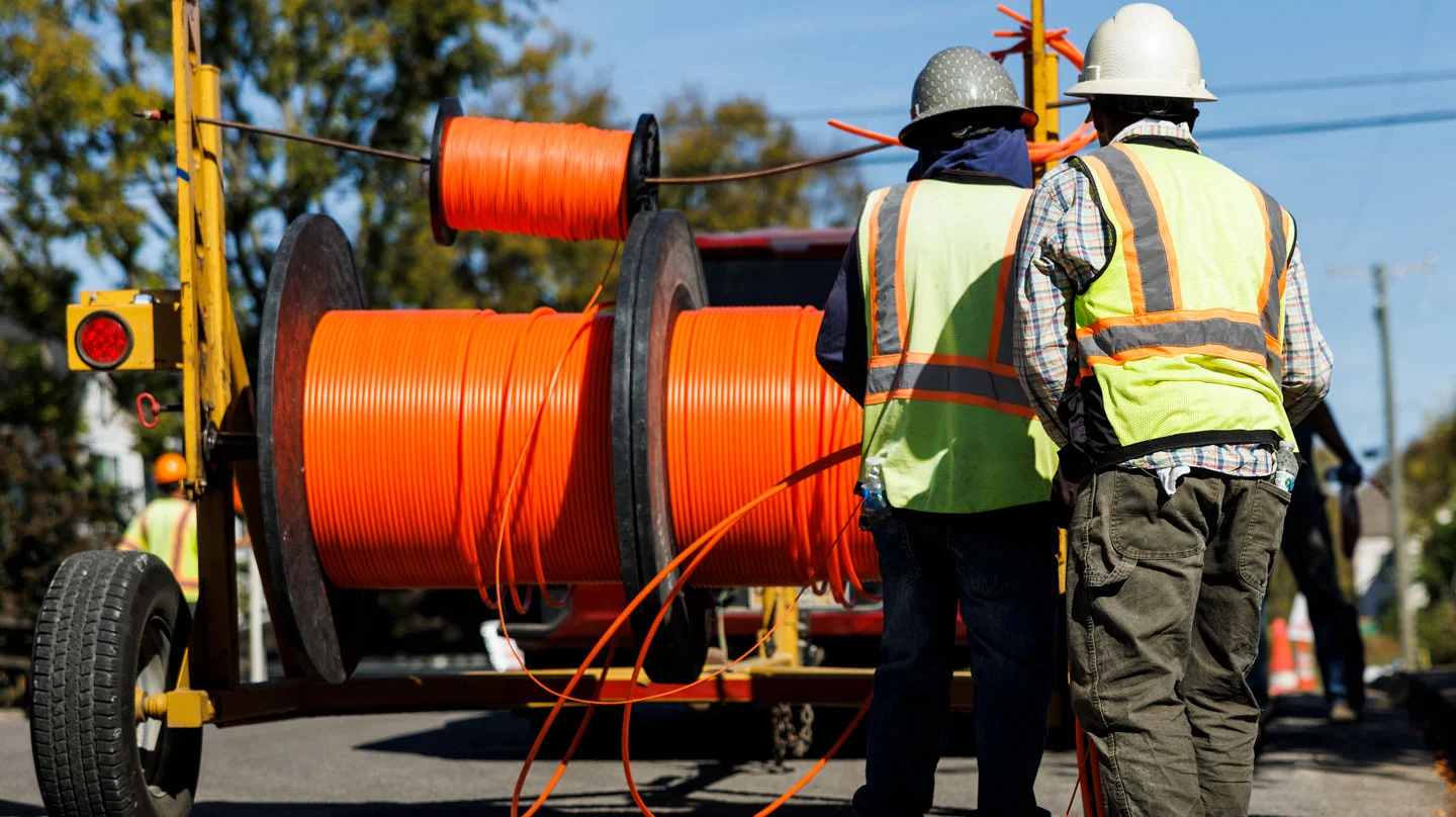 Insulation work is taking place on a street for fiber optic cables.