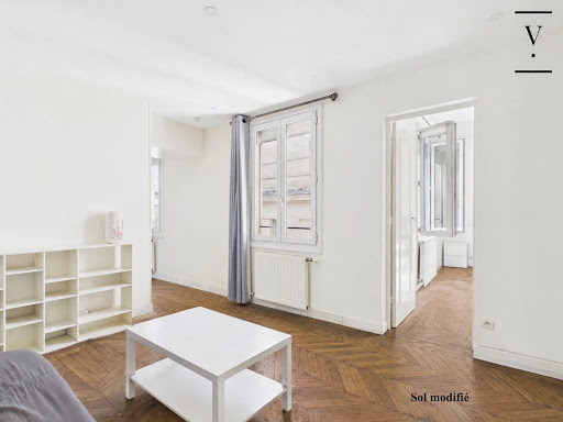 Bright living room herringbone parquet white shelves - Buy this luxury apartment / penthouse in Paris 3ème, 3 rooms, 1 bedroom