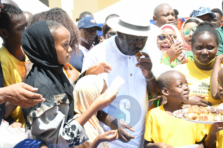 Azimio Leader Raila Odinga sharing cake with kids during celebrations of his 79th birthday in Malindi on Saturday, December 7, 2024.