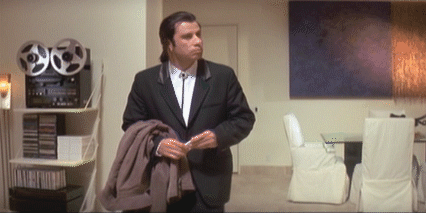 Vincent Vega from Pulp fiction looking around a room confused and shrugging.