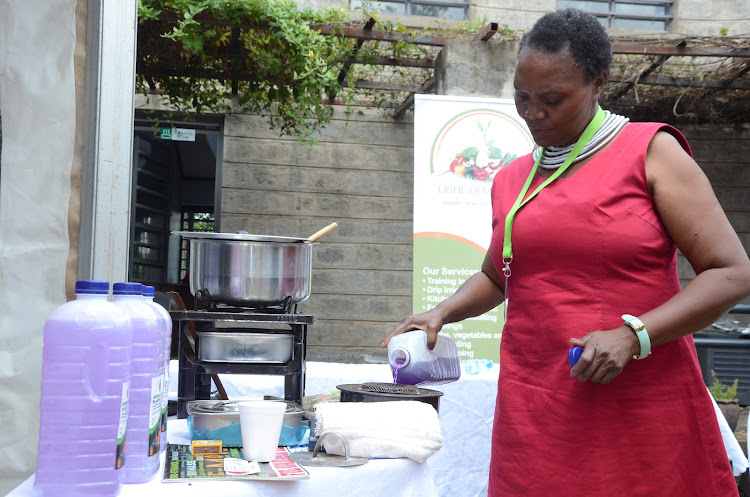 EMotor LTD founder Lorna Omuodo pouring fuel into a stove canister