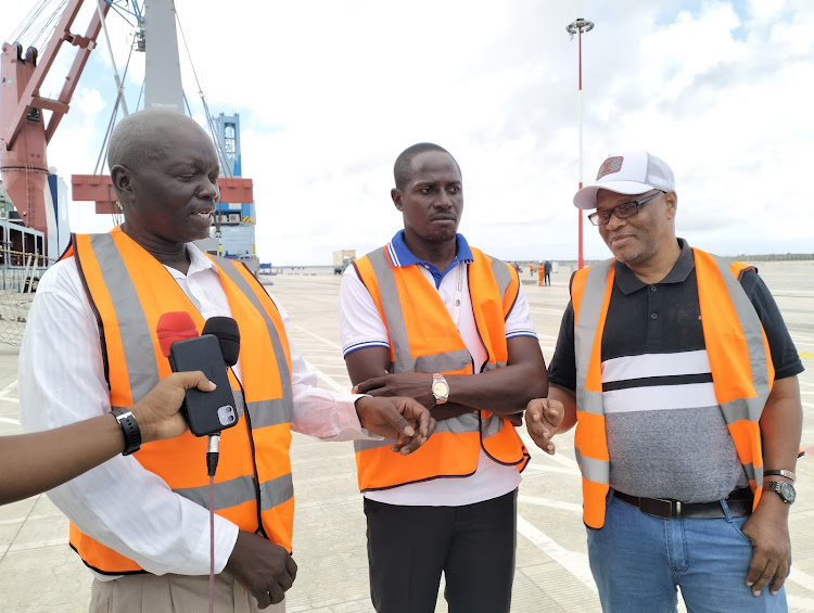From left,KPA Manager, Engineering Projects and Inspection Felix Ong'wen, KPA Manager, Conventional Cargo Engineering Swaleh Karuwa and Lamu Port Senior Maintenance Engineer Joseph Nyachwaya when they received the harbour mobile cranes at Lamu Port.