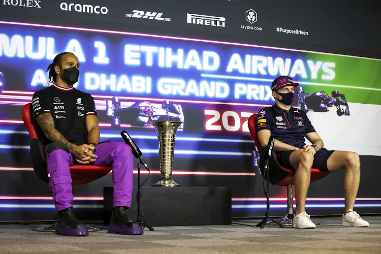 Lewis Hamilton of Great Britain and Mercedes GP, and Max Verstappen of Netherlands and Red Bull Racing talk in the Drivers Press Conference during previews ahead of the Formula One Grand Prix of Abu Dhabi at Yas Marina Circuit on December 9, 2021 in Abu Dhabi, United Arab Emirates.