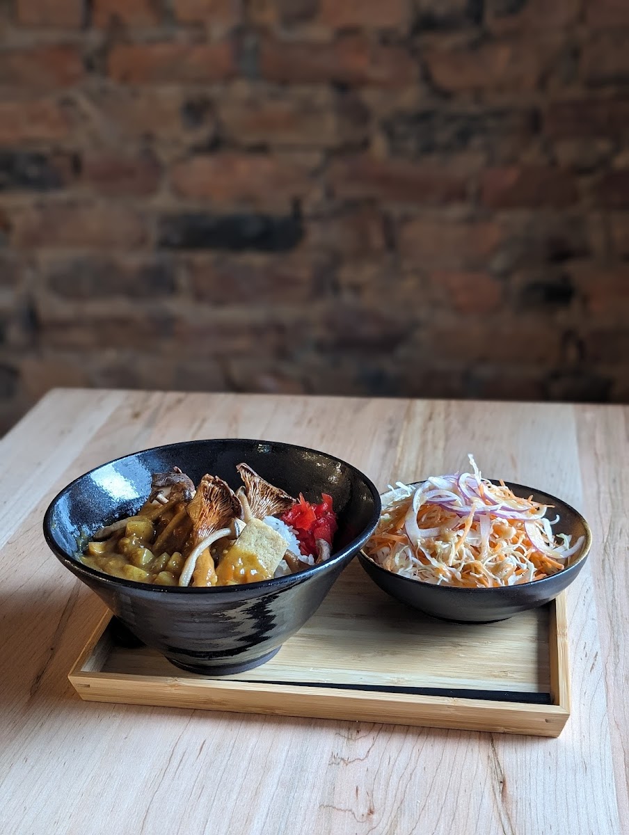 Japanese-style Curry with deep-fried Tofu and Mushrooms on Rice. Comes with small salad and fukujimzuke (Japanese pickles). All made free of gluten.