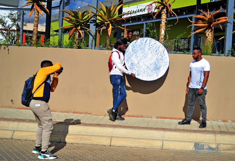 Thabiso Matjila prepares to take a picture of a client at the Paledi Mall in Turfloop near Polokwane. He is one of a legion of youths using photography to make a living across rural Limpopo.