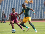 Christian Saile of Kaizer Chiefs is challenged by Bongani Sam of Moroka Swallows in the DStv Premiership match at Dobsonville Stadium in Soweto on Sunday.