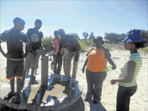 FILLING UP: Some of the Bona Bona residents queueing for water. Photo: Boitumelo Tshehle