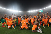 Ibrahim Sangare of Ivory Coast celebrates with the squad after their Africa Cup of Nations quarterfinal victory against Mali at Stade Peace Stadium in Bouake, Ivory Coast at Stade de la Paix in Bouaké on Saturday.