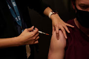 A nurse immuniser administers the AstraZeneca vaccine to a patient at a coronavirus disease (Covid-19) vaccination clinic at the Bankstown Sports Club during a lockdown to curb an outbreak of cases in Sydney, Australia, August 25, 2021.  