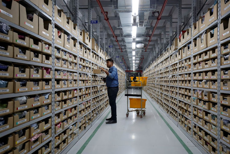 An employee at an Amazon fulfillment centre on the outskirts of Bengaluru, India. The company is heavily promoting its financial technology options in this country.