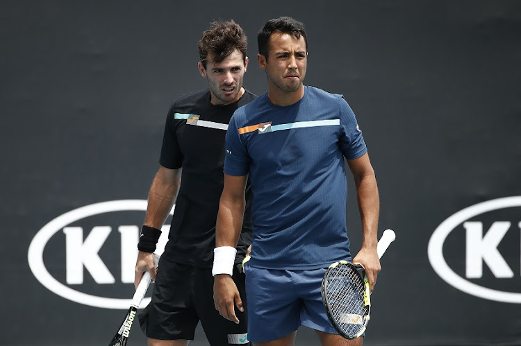 Hugo Dellien of Bolivia and Juan Ignacio Londero of Argentina talk tactics during their Men's Doubles first round match against Marcelo Arevalo of El Salvador and Jonny O'Mara of Great Britain on day three of the 2020 Australian Open at Melbourne Park on January 22, 2020 in Melbourne, Australia.