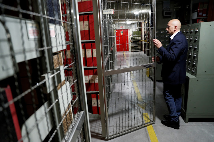 A man opens a door leading to the shelves where folders containing documents on Pope Pius XII, who reigned from 1939-1958, are stored inside the Vatican archives ahead of the full opening of the secret archives to scholars on March 2, at the Vatican, February 27 2020. Picture: GUGLIELMO MANGIAPANE/REUTERS