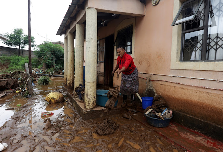 Bongiwe Zuma, 39, cleans her home after the deluge in Peace Valley.