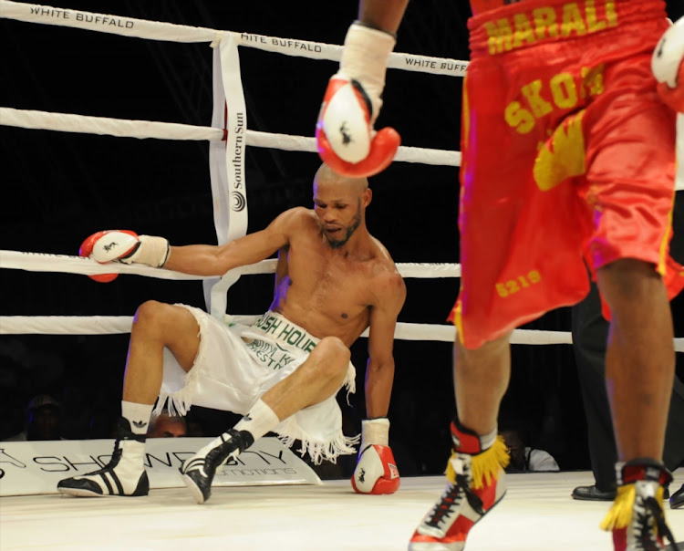 Ali Funeka (green and white trunks) during the World Boxing Federation Light Welterweight title bout against Zolani Marali at Monte Casino on November 19 2011 in Johannesburg.