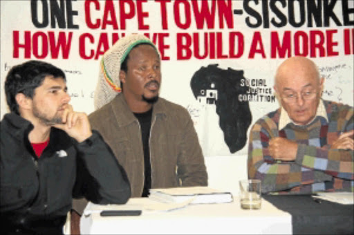 we're ALL EARS: Social Justice Coalition policy coordinator Gavin Silber, Informal Settlements Network leader Mzwanele Zulu and Cape Town development consultant Gerry Adlard listen to a speaker at the Irene Grootboom Memorial Lecture in Khayelitsha on Tuesday. PHOTO: LUTHO QWAMBI