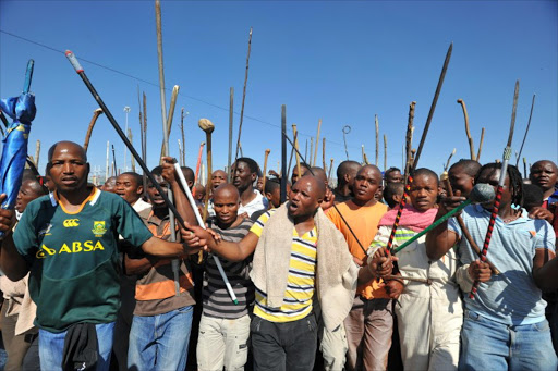 Thousands of South African mine workers walk on September 10, 2012 to the Lonmin mine in Marikana to try and stop other miners from going to work.