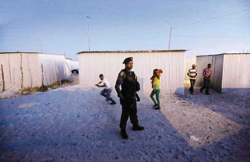 ON GUARD: Armed police officers accompanied a commission investigating the problems of policing in Khayelitsha.