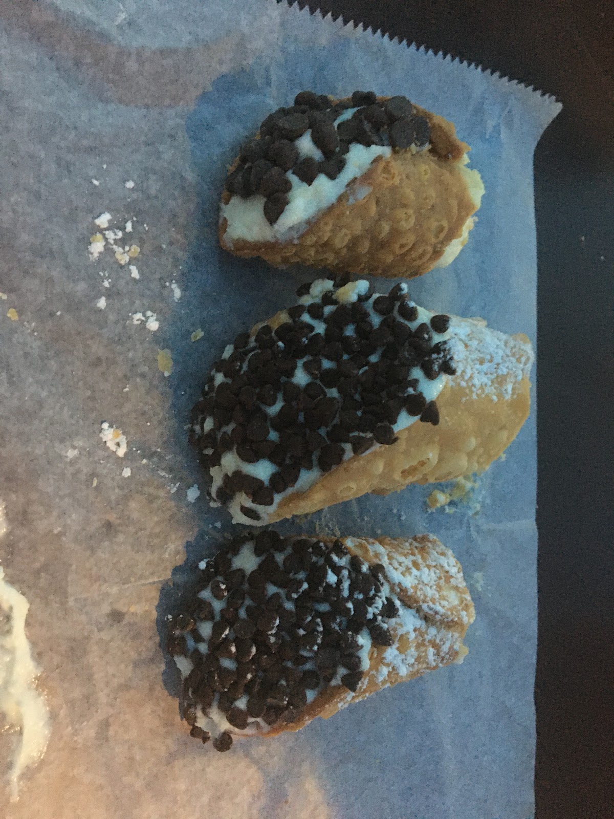 Cannoli with chocolate chips on the edges.