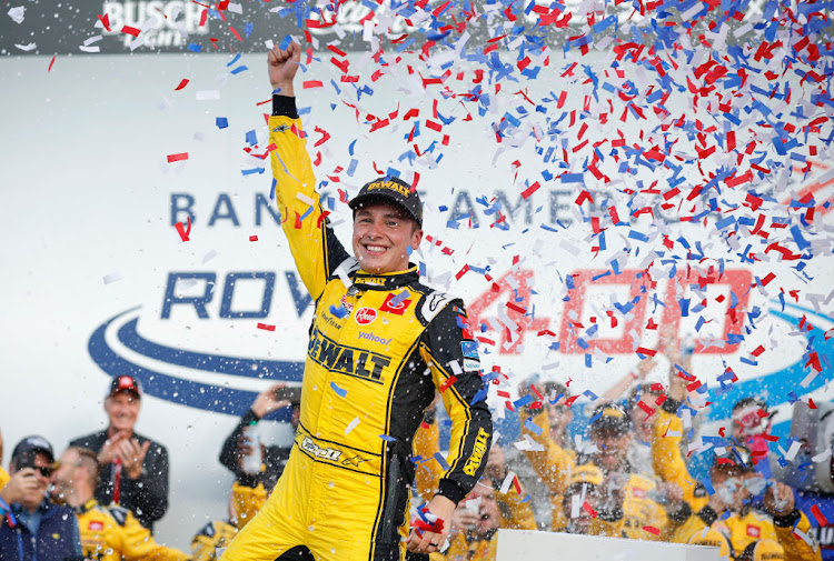 Christopher Bell celebrates in victory lane after winning the NASCAR Cup Series Bank of America Roval 400 at Charlotte Motor Speedway on October 9 2022 in Concord, North Carolina.