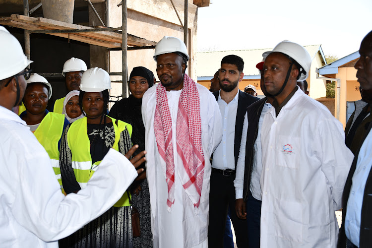 Trade and Investment CS Moses Kuria and Isiolo Governor Abdi Hassan Guyo at the abattoir in Isiolo on July 26, 2023