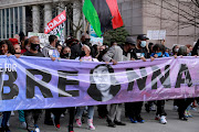 People attend a rally to mark one year since police officers shot and killed Breonna Taylor when they entered her home, in Louisville, Kentucky, US on March 13 2021. 