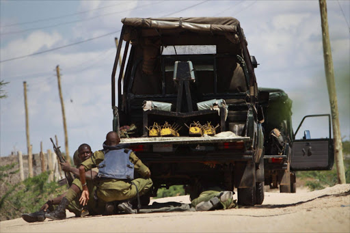 Kenyan soldiers take cover as shots are fired in front of Garissa University in Garissa town, located near the border with Somalia, some 370km northeast of the capital Nairobi, Kenya. EPA/DANIEL IRUNGU