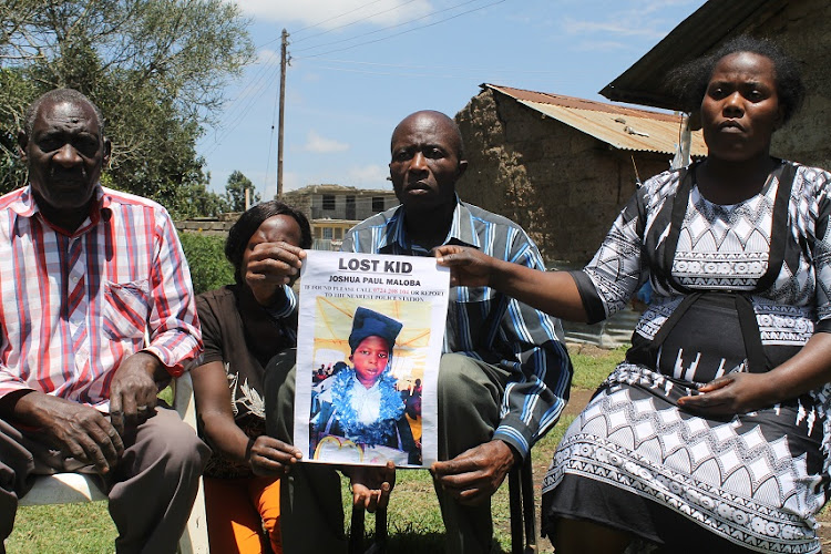 Peter Maloba with his wife Rebecca Auma and relatives address the press at home in Mihang'o, Njiru subcounty, on Monday