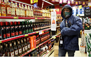 A man stocks up on alcohol at a liquor store. File photo.