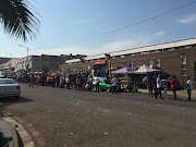 People wait outside a post office in Durban. Most of them are there to check the status of their special Covid-19 grants, which provide R350 per month.