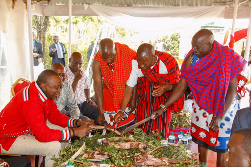 President Uhuru Kenyatta with Maasai leaders during the homecoming ceremony of Geothermal Development Corporation managing director and CEO Johnson ole Nchoe at his Rotian home, August 12, 2016/ PSCU