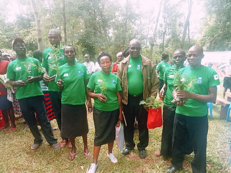 Members of Eshimwenyuli CBO during a tree planting event at Emuleche