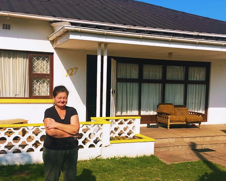 Sandy in front of her house.