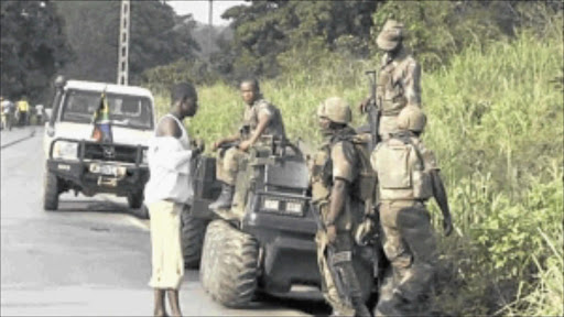 COMBAT: Armed South African soldiers chat with a man near Begoua, 17 km from the capital Bangui, last Saturday. Rebels in the CAR seized control of the capital Bangui, forcing President Francois Bozize to flee. PHOTO: REUTERS