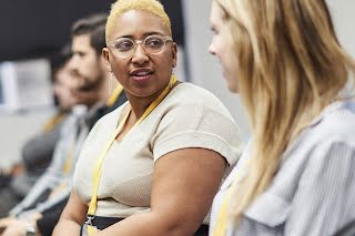 Woman smiling at other two women