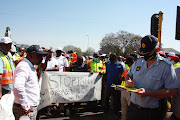 Silverton police station station commander Col Karel Swanepoel accepts a memorandum of grievances from taximen following a spate of killings.