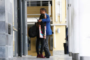 Relieved passengers embrace at the Gateway — the terminal for tourist trips to Robben Island.