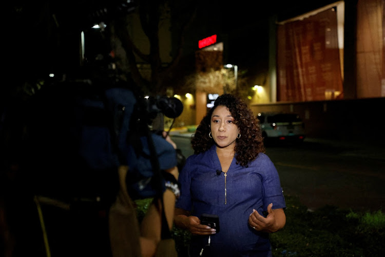 TV reporter Luana Munoz of an Orlando NBC affiliate reports at the Orlando Regional Medical Center, after a gunman opened fire on two television journalists reporting on a murder scene in the Pine Hills suburb, in Orlando, Florida, US, February 22, 2023.