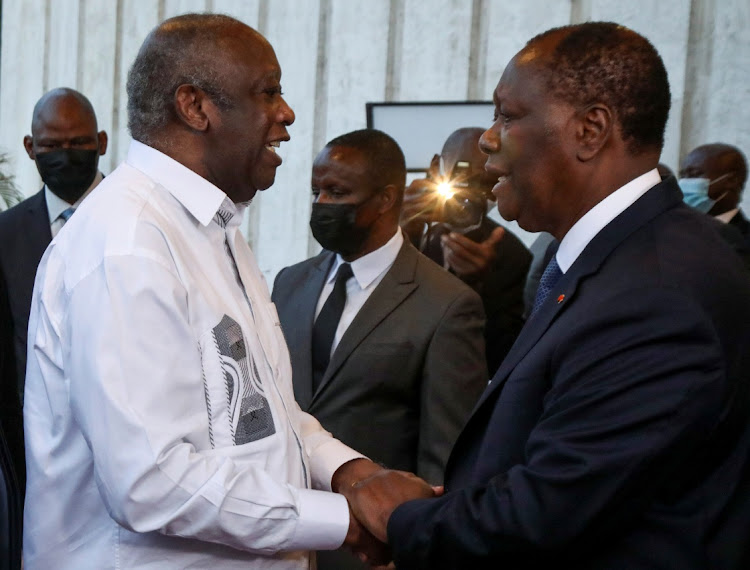 Ivory Coast's President Alassane Ouattara shakes hand with former President Laurent Gbagbo during a meeting at the presidential palace in Abidjan, Ivory Coast on July 27, 2021.