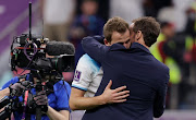 Harry Kane of England, who missed a late penalty, is consoled by manager Gareth Southgate after the team was knocked 2-1 by France in their World Cup quarterfinal at Al Bayt Stadium on December 10 2022 in Al Khor Qatar.