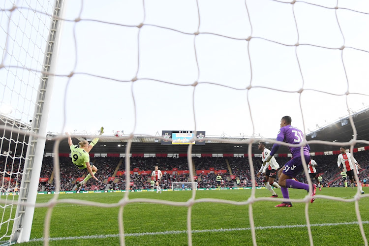 Erling Haaland scores the Manchester City s third goal with an overhead kick past Southampton goalkeeper Gavin Bazunu in the Premier League match at Friends Provident St. Mary's Stadium in Southampton on April 8 2023.