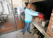 HEAT SAUCE:  Belhar resident Magdalene Schoeman keeps the monthly power bills down by cooking the  family supper on a fire.