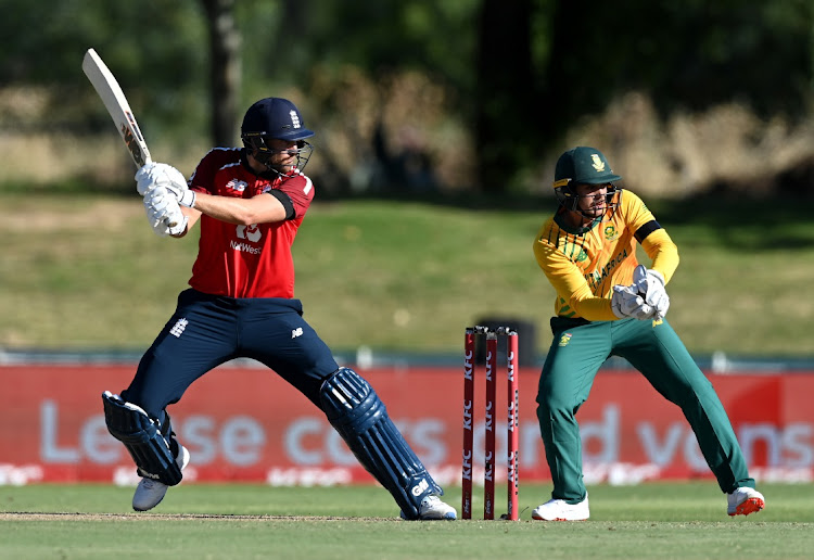 Dawid Malan of England plays a shot as Quinton de Kock of South Africa looks on during the 2nd T20 International at Boland Park on November 29, 2020 in Paarl, South Africa.