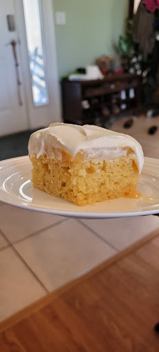 A slice of Passionfruit cake with Whipped Cream. 